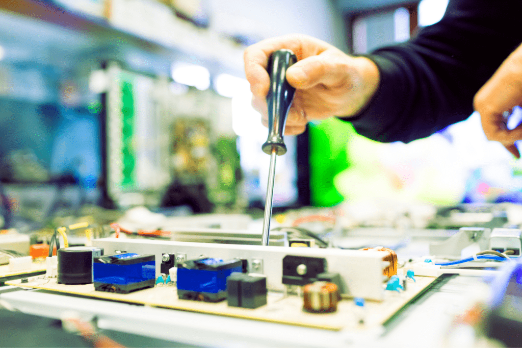 TV repair man working on big plasma televsion